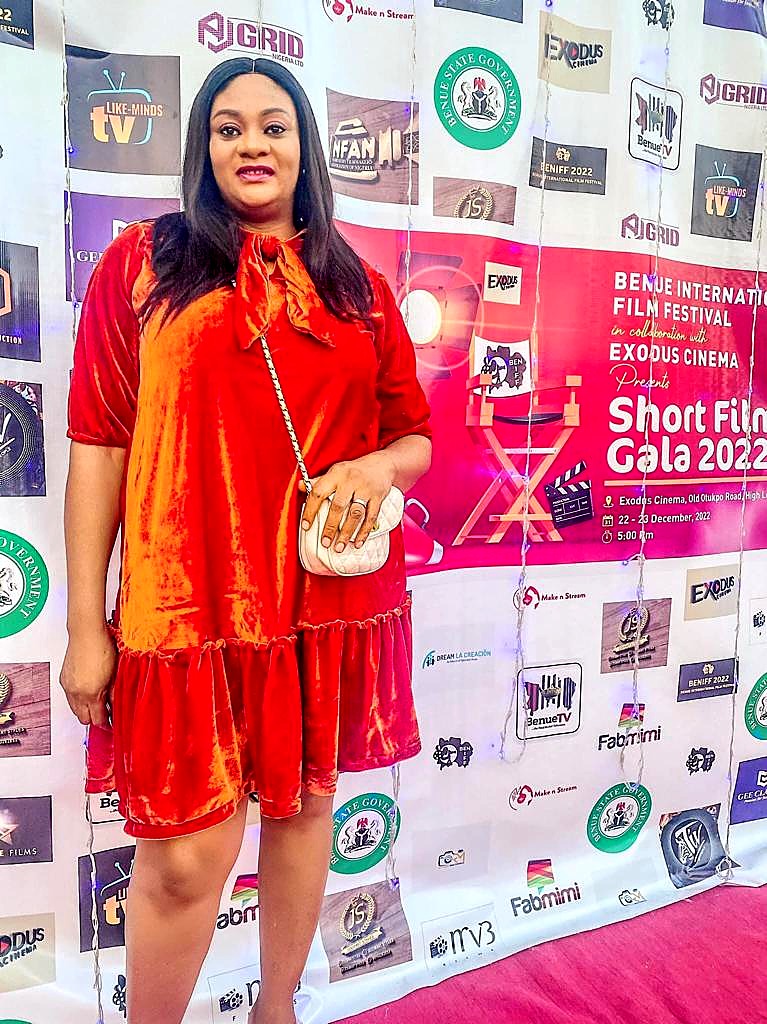 A guest in a red dress on the red carpet at the Benue Short Films Gala 2022