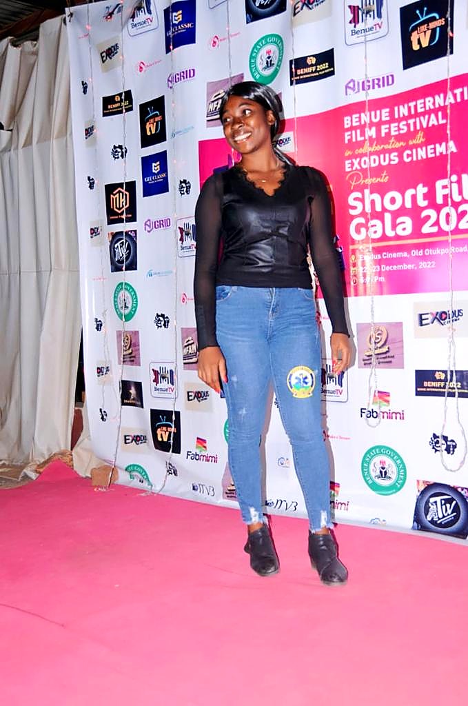 A guest posing on the red carpet at the Benue Short Films Gala 2022