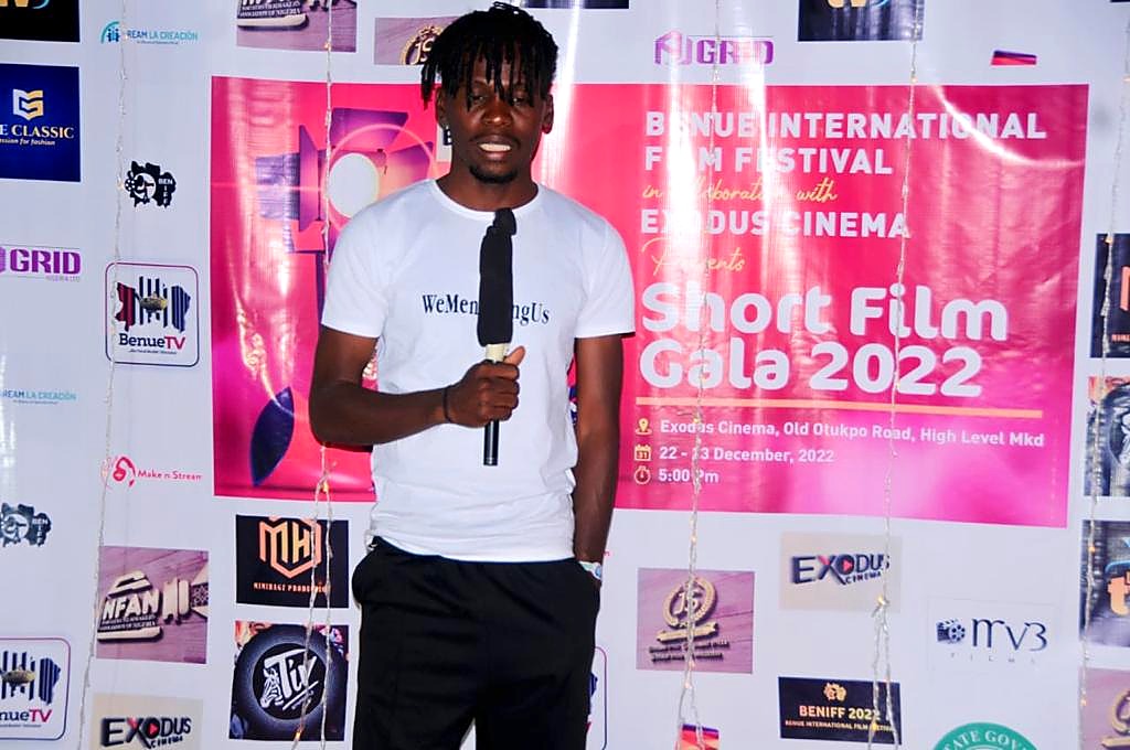 A guest in front of the Short Film Gala 2022 backdrop